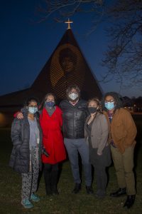 MCC faculty and students standing in front of the Memorial A.M.E. Zion Church with a projected image of Hester Jeffrey.