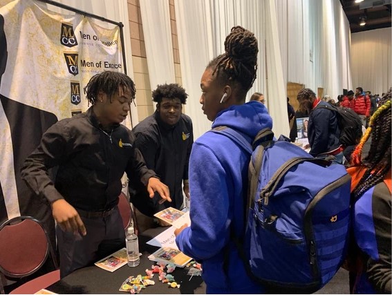 Student attending Men of Excellence booth