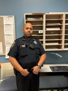 Sanjib Mudvary standing in an office with his uniform on.