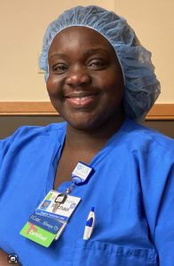 Rachael Baldwin wearing blue scrubs with a scrub cap covering her hair.