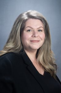 Professional headshot of Amanda Colosimo wearing a black blazer and smiling at the camera.