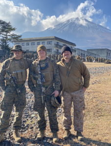 Sergeant Cam Bostley standing to the left with two other U.S. servicemen in Mount Fuji, Japan.