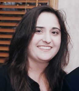 Michele Skehan wearing a black shirt and smiling at the camera.