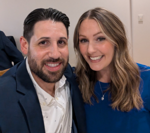 Stephanie Rivoli and her husband, Chris, smile at the camera while leaning close together.