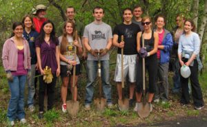 Members, with gardening gloves and shovels, preparing to planting trees as part of "Operation Green."