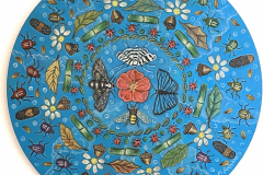 A round painting with an orange flower in the center is surrounded methodically by various bugs, including beetles, butterflies, moths, caterpillars and bees. The background is a blue sky with faint clouds.