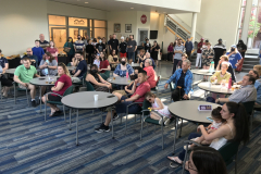 This image shows the group of people sitting at tables listening to the award ceremony.