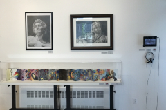 This is a photograph of the 44th annual student art exhibition installation. In this image we are seeing a small section of the right wall of the gallery with 4 pieces of art installed in the space.