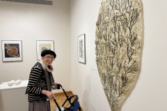 Artist Anne Havens admires a view of a large print.