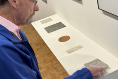 visitor enjoying opening reception for Anne Havens Exhibition.