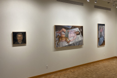 Installation shot of the galleryies left wall, showing three various paintings of varying size and subject matter.