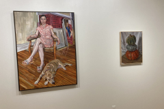 Installation shot of exhibition, a small painting of three gourds stacked is hung on the right, and one large painting of a woman is hanging on the left.