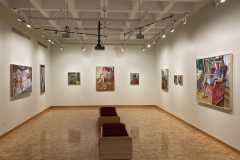 Wide intallation shot of the gallery, showing the left, rear, and right walls,  showing nine paintings of various sizes and subject matter.
