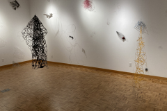 Image showing installation of art in the Mercer Gallery. Abstract forms on the wall and two hanging from the ceiling.