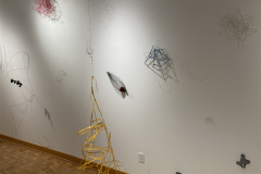 Image showing installation of art in the Mercer Gallery. Abstract forms on the wall and one hanging from the ceiling.