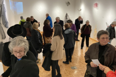 An image showing a group of people enjoying the art in the gallery.