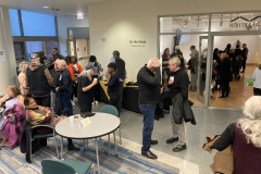 An image showing a group of people enjoying the art in the gallery.