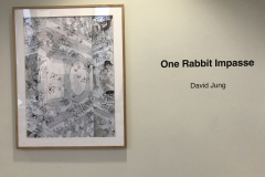 Installation shot of David Jung Exhibition. This image shows a painting and some wall text.