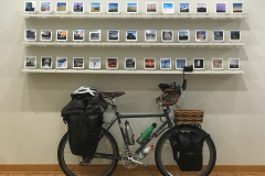 Gallery talk for. Depth Of Field. This image shows Donald Hyatt's work with his bicycle underneath the images.