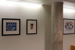 Detail image of artwork hanging in building 12 second floor. This area is known as Farrell Way. Artwork shown by Donald Colley, David Cowles, and Molly Macintyre..