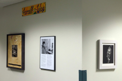 Detail image of artwork hanging in building 12 second floor. This area is known as Farrell Way. Artwork shown by Kathy Farrell, Jim Downer, Franzie Weldgen, and Lilee Reeden.