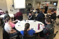 Artist Joe Ziolkowski presenting his pinhole photography to students in a classroom.