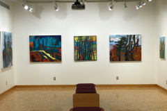 Installation shot of Judy Gohringers Mercer Gallery exhibition. This image mostly shows the rear wall of the gallery, which contains three very large and colorful landscape paintings. On the right and left walls we can see only a small amount of each painting there.