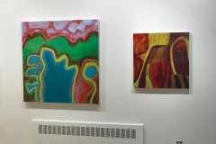 Installation shot of Judy Gohringers Mercer Gallery exhibition. This image is a detail shot of two large paintings found on the right wall. Each painting is an abstracted landscape composed of bright colors.
