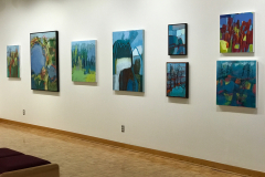 Installation shot of Judy Gohringers Mercer Gallery exhibition. This image shows the back part of the right wall, which contains eight colorful landscape abstractions of various sizes.