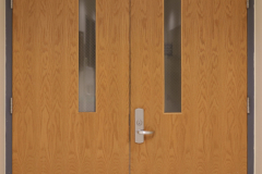 Detail image of artwork hanging in building 4 near the photography studio. This area is known as The Lagerway - Prather Gallery. We see the doorway leading to the photo studio, and a sign showing the name of the space..