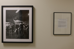 Detail image of artwork hanging in building 4 near the photography studio. This area is known as The Lagerway - Prather Gallery. Artwork shown by William H. Lagerway, and a sign dedicating the space.