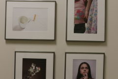 Detail image of artwork hanging in building 4 near the photography studio. This area is known as The Lagerway - Prather Gallery. Artwork shown by Amber Landschoot, Marleese Patterson, Justin Cruz, and Autumn Verbitsky