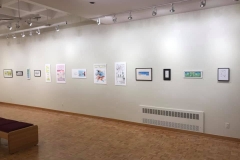 Installation shot of right gallery wall containing 13 comic illustrations.
