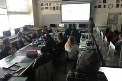 Image of Artist Nicholas Gurewitch lecturing in a classroom with students observing.