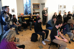 Image of Pat Bacon lecturing in the gallery with a number of people watching.
