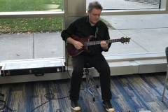 Guitarist playing music at Pat Bacon's opening reception.