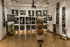 Installation image of Patti Russotti exhibition. This image shows large photos printed on cloth , and a sculpture in the foreground