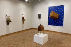 Detail image of the Robert Booth gallery installation, showing a detail of the back right corner, including four wall sculptures and one floor sculpture.
