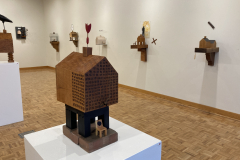 Detail image of the Robert Booth gallery installation, showing the right wall and  five works hanging there, as well as two floor sculptures.