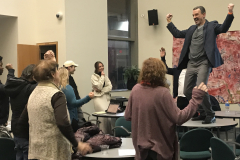 Another image showing the guest lecturer, standing on a table, and some of the audience.