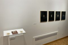 An image of the installation for the SUNY Brockport exhibition. This image shows some books and photographs on the front of the right wall.