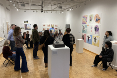 This image shows a group of people listening to the lecture in the gallery.