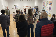 This image shows a group of people listening to the lecture in the gallery.