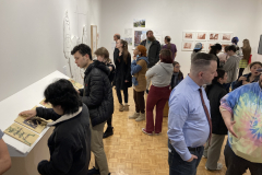 This image shows a group of people enjoying the opening reception in the gallery.