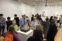 This image shows a group of people enjoying the opening reception in the gallery.