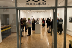 This image shows a group of people enjoying the opening reception in the gallery.