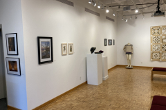 Installation shot of the gallery with art on the walls and on pedestals.