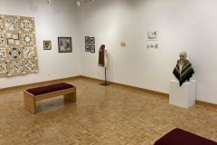 Installation shot of the gallery with art on the walls and on pedestals.