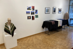Installation shot of the gallery with art on the walls and on pedestals.