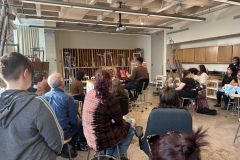 Photograph showing the artist demonstration in a painting one class.